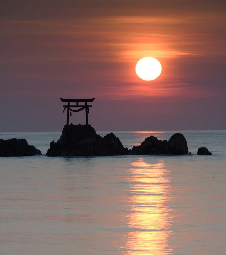 japanese scene with arch monument at sunset